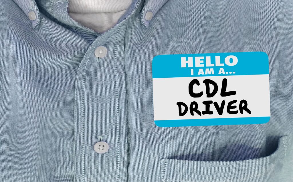 Close-up of nametag on chest reading CDL DRIVER