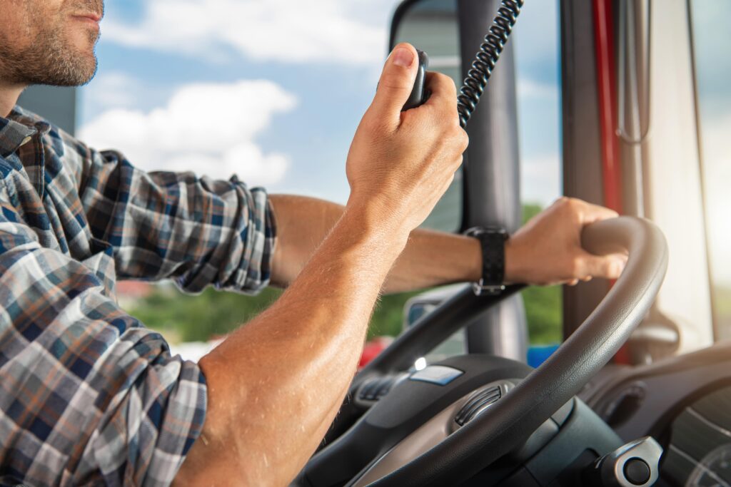 Semi truck driver talking on radio
