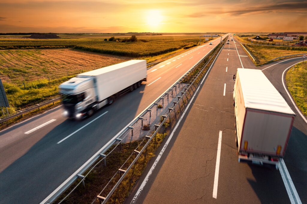 Trucks on highway at sunrise