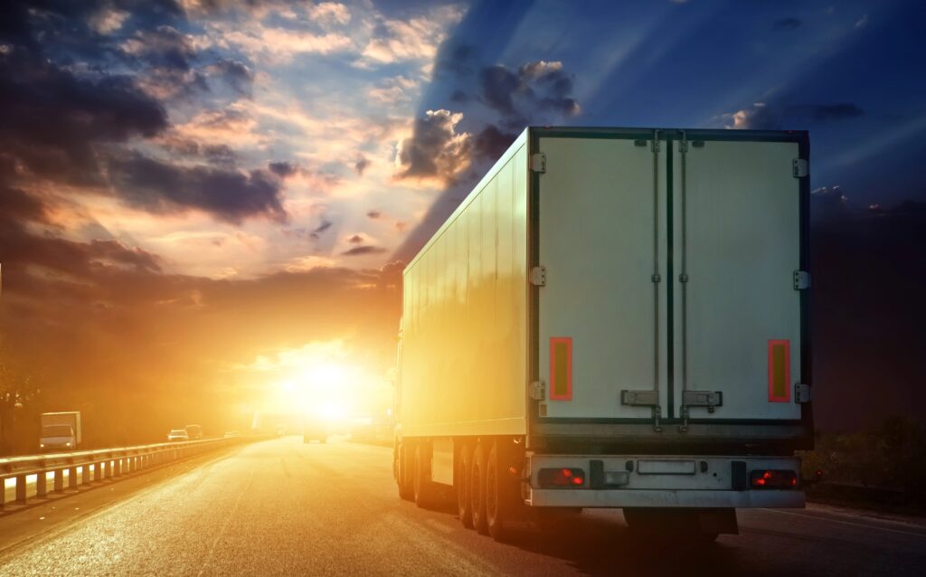 Truck on highway at sunset